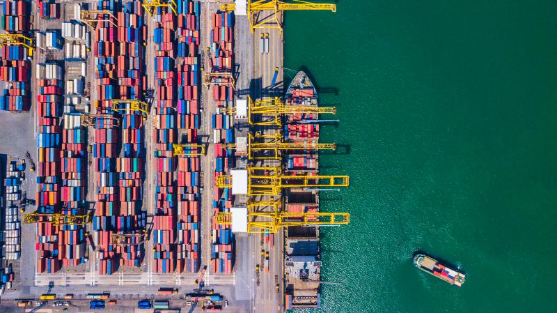 Overhead shot of an oceanic port filled with colorful cargo ships